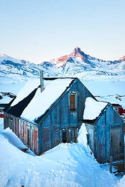 House in winter covered in snow, Tasiilaq, south eastern Greenland