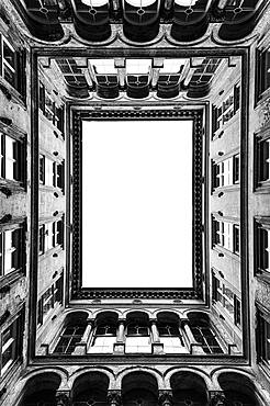 Architecture, the central courtyard of a tall historic building, windows and cornicing.