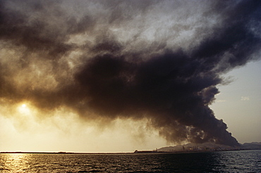 Oil refinery on fire on an island in the Arabian Gulf. United Arab Emirates.