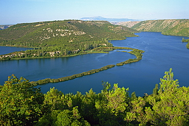 Lake and wooded hills in Krka National Park, Croatia, Europe