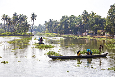 People crossing river in dug out canoe, Backwaters, Kollam, Kerala, India, Asia