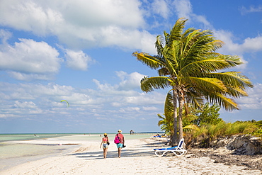 Couple walking along Playa El Paso, Cayo Guillermo, Jardines del Rey, Ciego de Avila Province, Cuba, West Indies, Caribbean, Central America