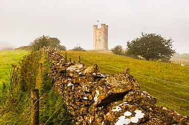 Misty sunrise at Broadway Tower, a National Trust property at Broadway, The Cotswolds, Gloucestershire, England, United Kingdom, Europe 