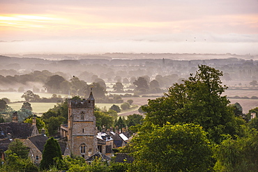 St. Lawrence Church and misty sunrise, Bourton-on-the-Hill, Gloucestershire, The Cotswolds, England, United Kingdom, Europe 