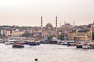 New Mosque (Yeni Cami) with Hagia Sophia (Aya Sofya) behind seen across the Golden Horn, Istanbul, Turkey, Europe