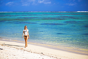 Woman walking along a tropical beach, Rarotonga Island, Cook Islands, South Pacific, Pacific