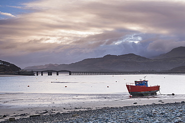 Fishing boat and Barmouth Bridge in Barmouth Harbour with Cader (Cadair) Mountains behind, Snowdonia National Park, North Wales, Wales, United Kingdom, Europe