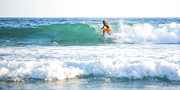 Surfers surfing on a beach, Nosara, Guanacaste Province, Pacific Coast, Costa Rica, Central America