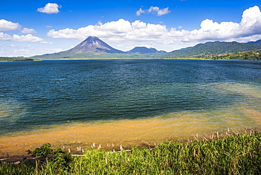 Arenal Volcano behind Laguna de Arenal (Arenal Lake), Alajuela Province, Costa Rica, Central America