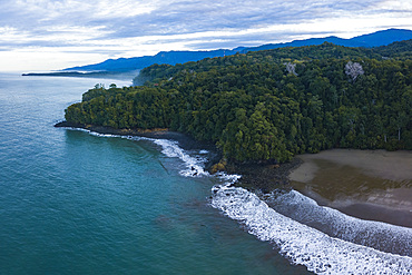 Drone view of Arco Beach and rainforest at sunrise, Uvita, Puntarenas Province, Pacific Coast of Costa Rica, Central America