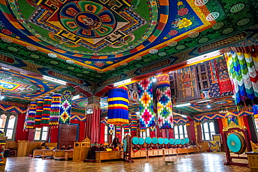 Buddhist monks worship with round gongs inside a prayer room at a monastery, Bhutan, Asia