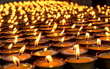 Candles lit for worship, Tamzhing Monastery, Bumthang District, Bhutan, Asia