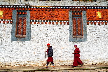 Bhutanese Pilgrims circumnavigate Tamzhing Monastery, Bumthang District, Bhutan, Asia