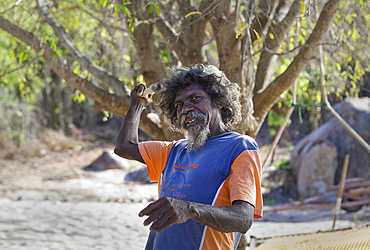 Portrait, Yolngu man, showing spear fishing action at Bawaka Homeland, East Arnhem Land, Northern Territory, Australia, Pacific