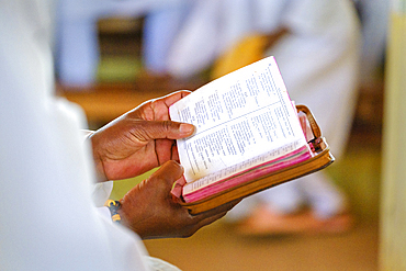 Churchgoers and the whole village dress in white on Sundays, singing through the streets and during the service, Soatanana Village.