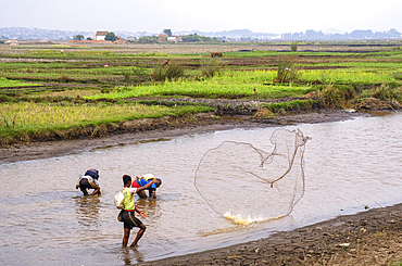 Malagasy people fishing the rivers in Antananarivo.