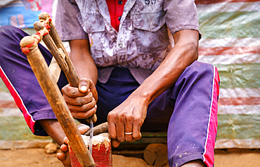 Malagasy artisans burning zebu horn to make household goods and trinkets.