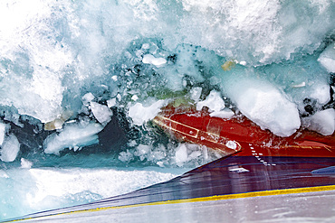 The Lindblad Expedition ship National Geographic Explorer pushing through ice in the Svalbard Archipelago, Norway, Arctic, Europe