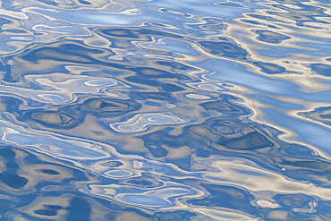 Reflections of the sky mirrored in the calm waters of Stanley in the Falkland Islands, South Atlantic Ocean.