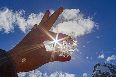 Ice held up to the sun near the Antarctic Peninsula during the summer months, Southern Ocean.