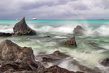 Surf breaking on lava shoreline at Gardner Bay on Espanola Island in the Galapagos Island Archipelago, UNESCO World Heritage Site, Ecuador, South America