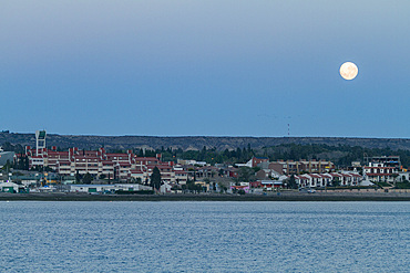 Full moon setting in the early morning over the town of Puerto Madryn, Argentina, South Atlantic Ocean.