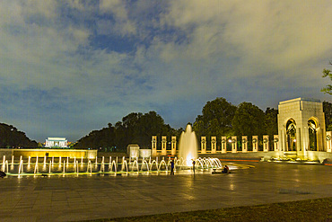 Views at night of the fountains at the U.S. National World War II Memorial, Washington, D.C., United States of America.