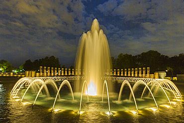 Views at night of the fountains at the U.S. National World War II Memorial, Washington, D.C., United States of America.