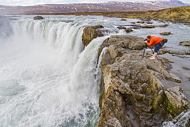 Photographer at Goðafoss, Icelandic: waterfall of the gods. Iceland.