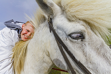 Young boy with Icelandic pony on Heimaey Island, Iceland