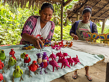 Women showing off their hand made wares in a small village deep within the Pacaya Samiria Preserve, Peru.
