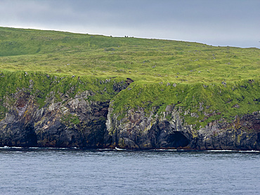 Rocky cliffs on Kagamil Island. Kagamil Island is one of the four mountains of the Aleutian Archipelago, Alaska.