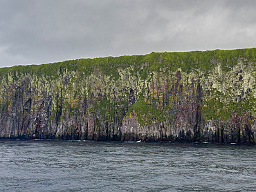Rocky cliffs on Kagamil Island. Kagamil Island is one of the four mountains of the Aleutian Archipelago, Alaska.