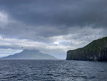 Rocky cliffs on Kagamil Island. Kagamil Island is one of the four mountains of the Aleutian Archipelago, Alaska.