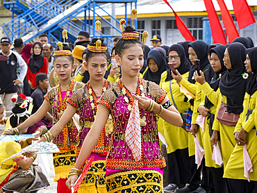 Locals in traditional costume greet our ship in the island of Banda Neira, Moluccas, Indonesia.