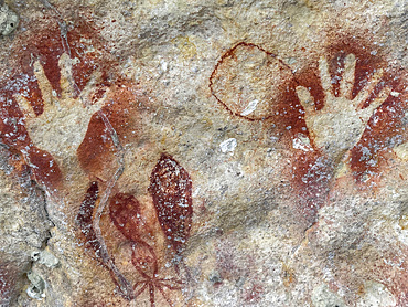 Ancient rock art painted on the limestone cliffs in Berau Bay on the island of Papua, Indonesia.