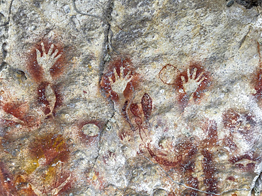 Ancient rock art painted on the limestone cliffs in Berau Bay on the island of Papua, Indonesia.