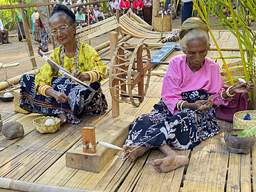Women making thread for textiles in the village of Liangawo, on Flores Island, Lesser Sunda Islands, Indonesia.