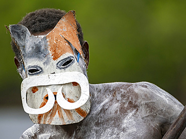 Male paddler from the village of Uwus perform in a ritualistic greeting ceremony, Asmat Region, Papua, Indonesia.