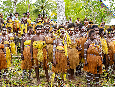 Females from the village of Uwus perform a greeting ceremony in traditional regalia, Asmat Region, Papua, Indonesia.