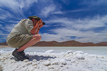 Tourists taking photos at the Salinas salt mine on Isla del Carmen in the Gulf of California, Baja California Sur, Mexico.