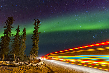Long exposure of Jeep lights and Aurora Borealis, on the Great Slave Lake, Northwest Territories, Canada.