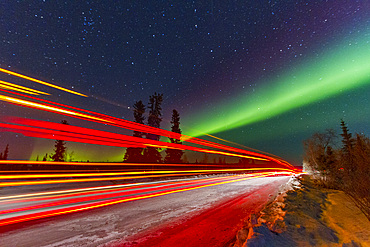 Long exposure of Jeep lights and Aurora Borealis, on the Great Slave Lake, Northwest Territories, Canada.