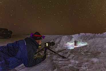 Canadian photographer Gilles Pucheu on the frozen solid Great Slave Lake, Northwest Territories, Canada.