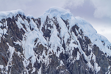 Snow-covered mountains in Crystal Sound, south of the Antarctic Circle, Antarctica, Southern Ocean.