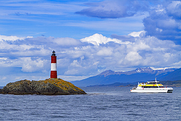 A commercial whale watching boat near a small islet in the Beagle Channel near Ushuaia, Tierra del Fuego, Argentina.