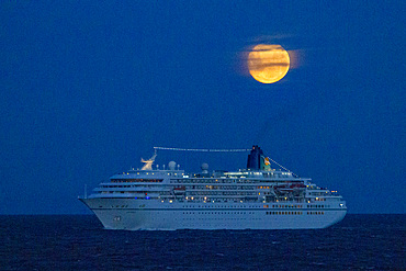 A cruise ship under a full moon in the Beagle Channel near Ushuaia, Tierra del Fuego, Argentina.