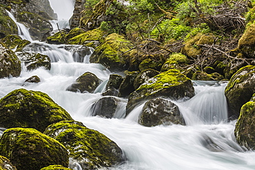 Slow shutter speed silky water of the Olden River as it flows along Briksdalen, Olden, Nordfjord, Norway, Scandinavia, Europe