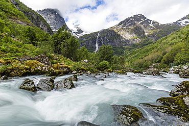 Slow shutter speed silky water of the Olden River as it flows along Briksdalen, Olden, Nordfjord, Norway, Scandinavia, Europe