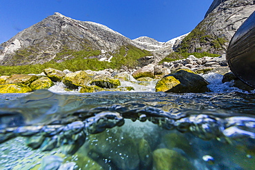 Above and below view of ice melt waterfall cascading down in Svartisen National Park, Melfjord, Nordfjord, Norway, Scandinavia, Europe